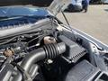 A 2018 Ford F-150 engine compartment showing various components including the air intake and coolant reservoir