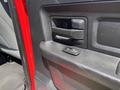 Close-up of a door handle and controls inside a 2013 RAM 2500 vehicle interior
