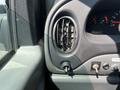 Close-up view of the dashboard vent and controls of a 2005 Ford Econoline with black and gray interior elements