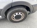 A close-up of a 2019 Ford Transit's wheel showing the tire and rim with a rugged tread pattern