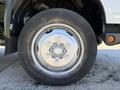 Close-up of a Hino 195 truck wheel showing a silver alloy rim with a black tire and exposed lug nuts