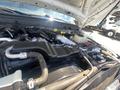 Engine compartment of a 2016 Ford F-350 SD with various components including hoses wires and an air intake system visible