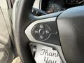 Steering wheel close-up showing controls for cruise control on a 2018 Chevrolet Colorado