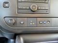 Close-up of the dashboard control panel of a 2024 Chevrolet Express featuring buttons for audio settings climate control and additional functions