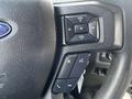 Steering wheel controls of a 2017 Ford F-250 SD featuring buttons for volume and phone functions