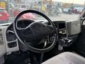 Interior view of a 2012 International 4300 truck showing the steering wheel dashboard and control panel