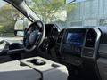 Interior view of a 2021 Ford F-250 SD showing the steering wheel dashboard and center console with touchscreen display and controls
