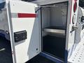 A 2017 Chevrolet Colorado with an open service compartment featuring a metal shelf and interior space for equipment.