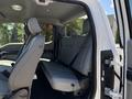 Interior view of a 2020 Ford F-350 SD showing the back seat with gray upholstery and seatbelts