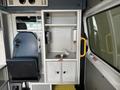 Interior of a 2020 Mercedes-Benz Sprinter 2500 featuring a driver's seat and a compact kitchenette area with a sink and storage cabinets