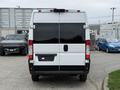 White 2020 RAM Promaster van viewed from the rear with dark tinted windows and no license plate attached