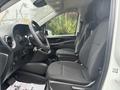 Interior of a 2021 Mercedes-Benz Metris showing the driver's seat steering wheel and passenger seat with fabric upholstery