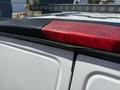 A close-up of the rear light assembly on a 2017 Chevrolet Express showing the red light and part of the vehicle's roof features