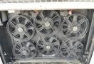 A series of six black ventilation fans arranged in two rows on a metal panel
