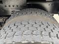 Close-up of a worn tire from a 2013 Freightliner 114SD showing detailed tread patterns and visible wear on the surface