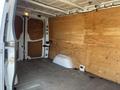 Interior of a 2016 Mercedes-Benz Sprinter van with bare plywood walls and a flat floor showing no cargo or shelving