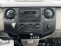 Dashboard of a 2009 Ford F-550 featuring audio controls climate dials and several buttons for vehicle functions