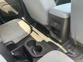 Interior view of the rear seats in a 2017 Chevrolet Colorado featuring gray cloth upholstery a center console and cup holders