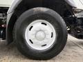 Close-up of a large Goodyear tire mounted on a white rim from a 2012 International 7400 truck showcasing the tread design and wheel details