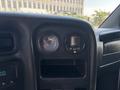 Dashboard of a 2005 GMC C7500 Topkick showing two circular gauges one for temperature and one for fuel level