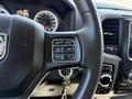 Close-up of the steering wheel of a 2019 RAM 1500 Classic featuring buttons for gear control cruise control and a key ignition area