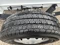 Close-up of a wheel with a rugged tire featuring deep treads designed for traction and durability on a 2023 RAM Promaster 3500