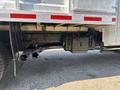 Close-up of the exhaust system and undercarriage of a 2019 Ford F-550 showing dual exhaust pipes and a large black fuel tank