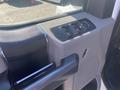 Close-up of the interior door panel of a 2017 Ford F-150 featuring control buttons for windows and door locks along with a textured armrest