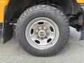 Close-up of a tire and wheel of a 2017 Ford F-250 SD showing a rugged all-terrain tire with distinct tread patterns and a metallic rim