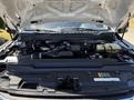 Engine bay of a 2020 Ford F-350 SD featuring various components such as the engine block air intake and other mechanical parts visible under the hood