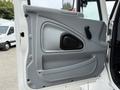 The image shows the door panel of a 2006 International 4300 featuring a gray interior with a black handle and a triangular black panel