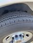 Close-up of a tire on a 2016 GMC Savana showcasing the tread pattern and alloy wheel rim