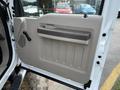 Interior door panel of a 2008 Ford F-450 SD with a large handle and textured surface