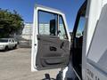 A 2008 International DuraStar truck with the driver's side door open showing the interior door panel and window