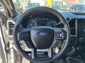Steering wheel of a 2017 Ford F-550 featuring the Ford logo controls on the wheel and dashboard gauges visible behind