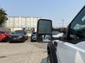 A 2009 Ford F-450 Super Duty with a side mirror extending outward