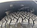 Close-up of a rugged tire on a 2017 Ford F-150 showcasing a deep tread pattern and sturdy construction