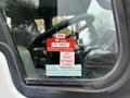A close-up of the certification sticker on the windshield of a 2009 UD Trucks UD 3300 displaying the approval details and months listed for validity