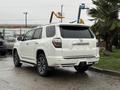 A white 2018 Toyota 4Runner with a sleek design and alloy wheels parked in a lot