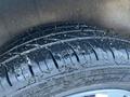 Close-up of a tire from a 2017 Ford Transit Connect showing tread depth and water droplets on the surface