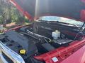 A 2013 RAM 2500 truck with the hood open showcasing the engine compartment and components including the battery and fluid reservoirs