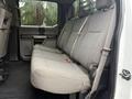 The image shows the interior of a 2019 Ford F-350 SD with a gray bench seat in the back row