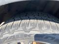 A close-up of a tire from a 2016 Ford Escape showing tread pattern and sidewall branding