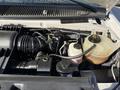 2012 Ford Econoline E-450 engine compartment with visible components including the air intake a coolant reservoir and various hoses and wiring