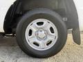 Close-up of a silver alloy wheel from a 2013 Toyota Tacoma with six spokes and a tire showing prominent tread patterns