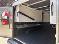 Interior view of a 2019 Ford F-150 truck bed showing storage compartments and a metal shelf