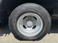 Close-up of a wheel from a 2012 Ford Econoline with a silver rim and a black tire
