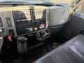 The interior dashboard of a 2017 International 4300 featuring various control panels gauges and a gear shift along with a cup holder and a driver's seat