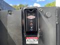 Control panel for a hydraulic system featuring buttons for activation and power with a warning label indicating danger from moving parts