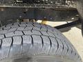 Close-up of a treaded tire from a 2014 Ford F-250 SD showing deep grooves and rugged design ideal for off-road conditions